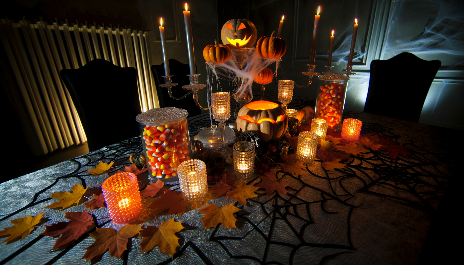 Enchanting Halloween party table with pumpkins, candles, and candy corn decorations.